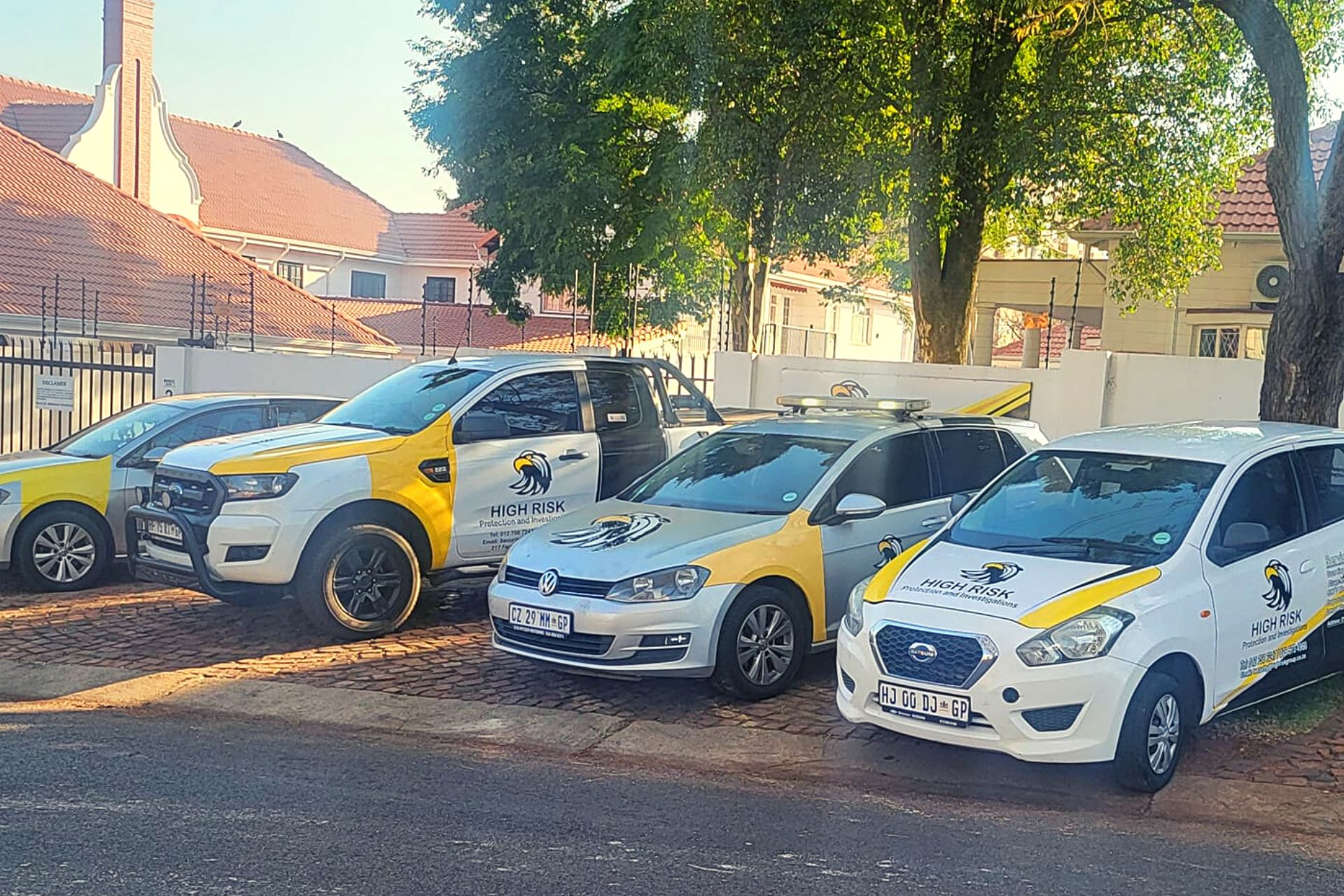 Fleet of High Risk Protection and Security service vehicles parked in a row, featuring branded liveries, ready for deployment in Pretoria.