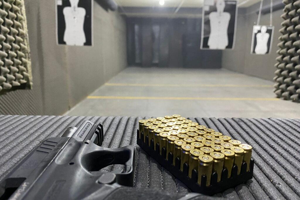 Firearm and ammunition on a shooting range, highlighting a professional training environment for armed response officers